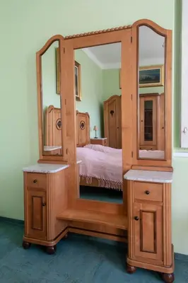 a bedroom with a bed and a large mirror at Vila Jasna in Radovljica