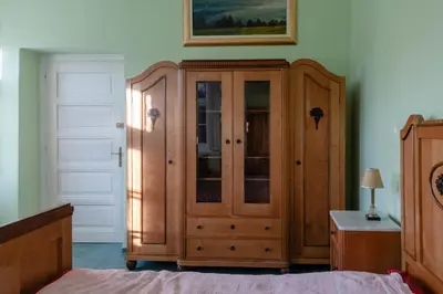 a bedroom with a wooden cabinet and a bed at Vila Jasna in Radovljica