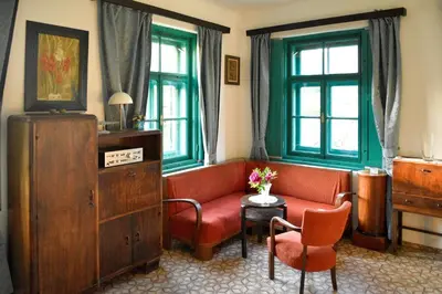 a living room with a red couch and a table at Vila Jasna in Radovljica