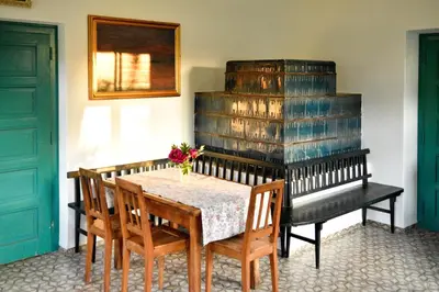 a dining room with a table and a stack of wine barrels at Vila Jasna in Radovljica
