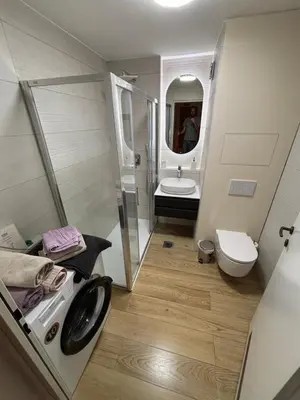 a bathroom with a shower and a toilet and a sink at Comfy flat in city-FREE parking in Ljubljana