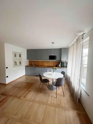 a kitchen and dining room with a table and chairs at Comfy flat in city-FREE parking in Ljubljana