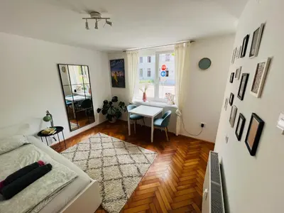a living room with a couch and a table at Paula’s cosy place in the center of Ljubljana in Ljubljana