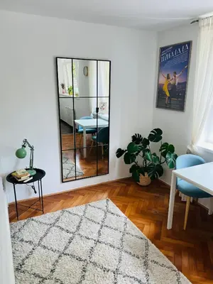 a living room with a mirror and a table at Paula’s cosy place in the center of Ljubljana in Ljubljana