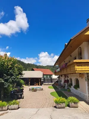 a building with a courtyard with plants in front of it at Guest House Kveder in Škofja Loka