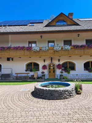 a large house with a building with a patio at Guest House Kveder in Škofja Loka