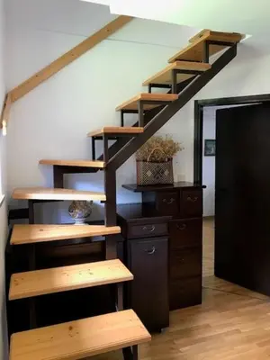 a wooden staircase in a room with a desk at Holiday Home Anja in Bohinj