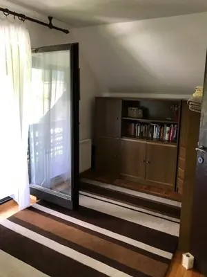 a room with a sliding glass door and a book shelf at Holiday Home Anja in Bohinj