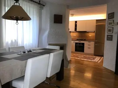a kitchen and dining room with a table and chairs at Holiday Home Anja in Bohinj