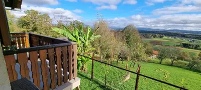 a balcony with a view of a green field at Marinčeva zidanica in Črnomelj