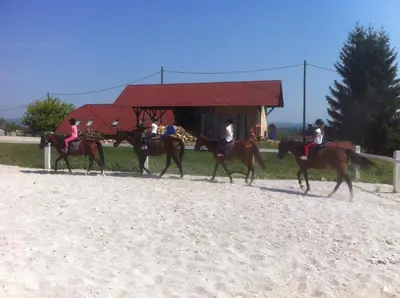 a group of people riding horses in front of a building at Apartments Pri Adamsovih in Čatež ob Savi