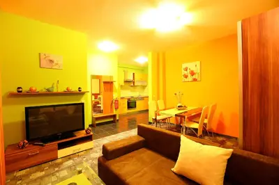 a living room with a television and a dining room at Apartments Pri Adamsovih in Čatež ob Savi