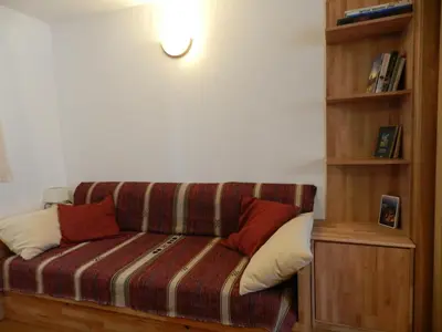 a couch with two pillows on it in a room at Apartment Kenda in Bovec