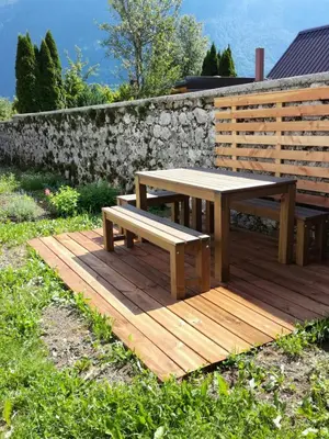 a picnic table and bench on a wooden deck at Apartment Kenda in Bovec