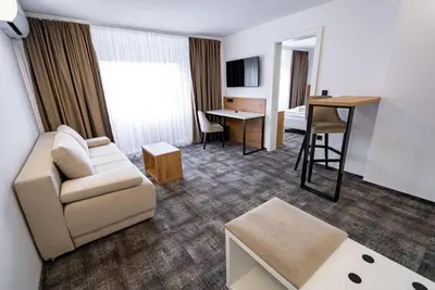 a living room with a couch and a table at City Hotel Krško in Krško