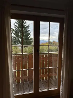 a window with a view of the mountains through it at A View to a Hill in Sveti Florijan pri Šoštanju