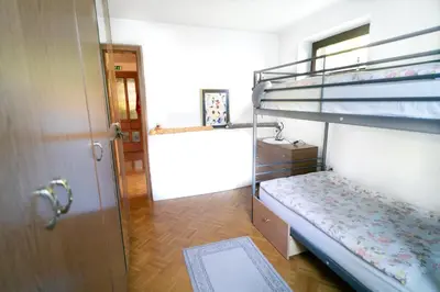 a room with two bunk beds and a door at Apartment Satya in Dobrna