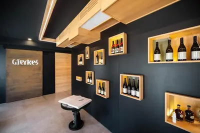 a wine tasting room with wine bottles on the wall at Posestvo Gjerkeš in Rogašovci