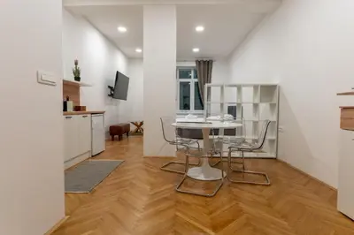 a kitchen and living room with a table and chairs at Villa Sofija in Ljubljana