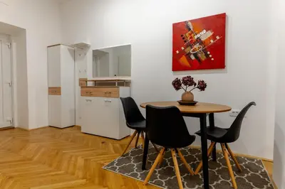 a dining area with a table and chairs in a room at Villa Sofija in Ljubljana