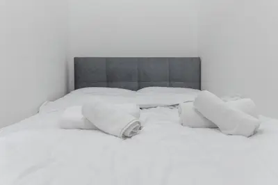 a white bed with white pillows on it at Villa Sofija in Ljubljana