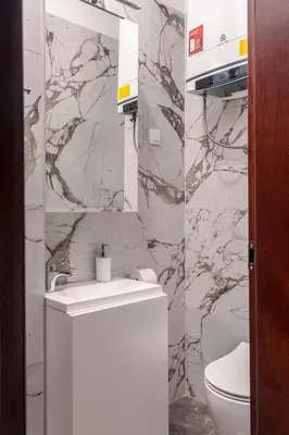 a bathroom with a white sink and a toilet at Villa Sofija in Ljubljana