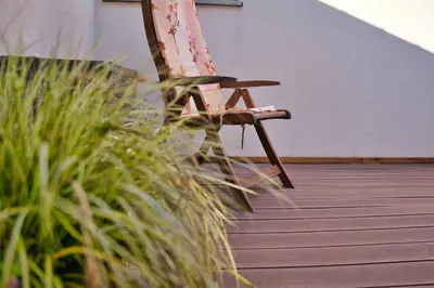 a chair sitting in a room with some grass at Hisa idej in Sežana