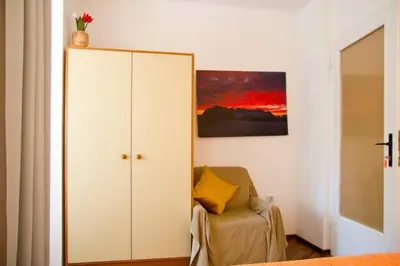 a room with a white cabinet and a chair at Apartment House Anton with free parking in Bovec
