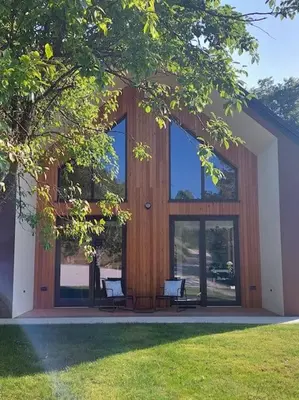 a building with two chairs in front of it at HERBALIJA Apartment Amalija - in the embrace of wellbeing in Podčetrtek