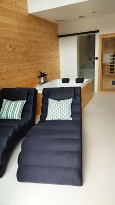 a living room with a couch and a kitchen at HERBALIJA Apartment Amalija - in the embrace of wellbeing in Podčetrtek