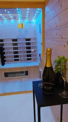 a bottle of wine sitting on a table with a glass at HERBALIJA Apartment Amalija - in the embrace of wellbeing in Podčetrtek