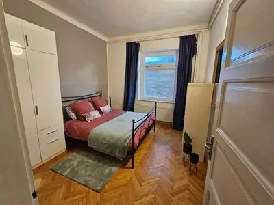 a small bedroom with a bed and a window at Apartma Pekrska vila in Limbuš