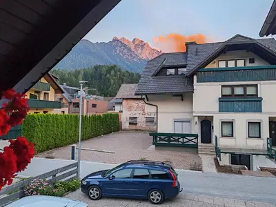a blue car parked in front of a house at Apartments & Rooms Smučka in Kranjska Gora