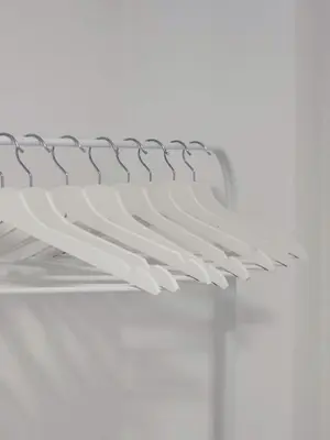 a white shelf in a room with a white wall at Stara Pošta Apartment 1 in Grosuplje