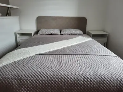 a bed with two pillows on it in a bedroom at Stara Pošta Apartment 5 in Grosuplje