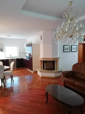 a living room with a couch and a table and a chandelier at Apartma Bistrica in Slovenska Bistrica