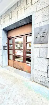 a store front with ajar doors on a building at Apartment Tivoli in Ljubljana