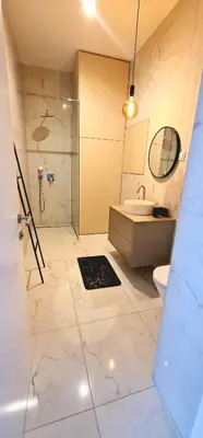 a bathroom with a shower and a toilet and a sink at Apartment Tivoli in Ljubljana