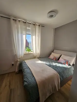 a bedroom with a large bed with a window at soba v Pekrski vili in Limbuš