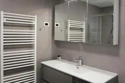 a bathroom with a sink and a mirror at Apartment Simona in Kranjska Gora