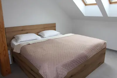 a bedroom with a bed with two pillows on it at Apartment Simona in Kranjska Gora