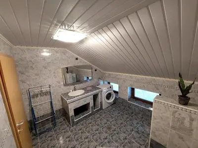 a bathroom with a sink and a washing machine at Countryside Apartment Agnes in Šentjošt nad Horjulom