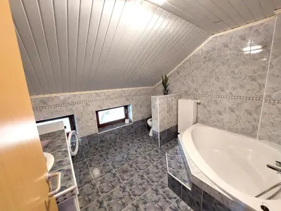 a large bathroom with a tub and a sink at Countryside Apartment Agnes in Šentjošt nad Horjulom