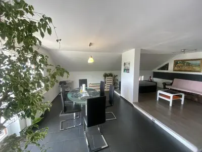 a living room with a table and chairs and a couch at Countryside Apartment Agnes in Šentjošt nad Horjulom