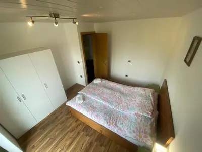 a small bedroom with a bed in the corner at Countryside Apartment Agnes in Šentjošt nad Horjulom