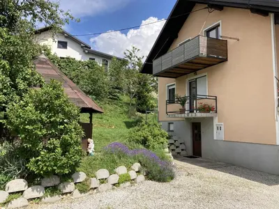 a house with a balcony on the side of it at Countryside Apartment Agnes in Šentjošt nad Horjulom