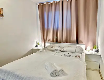 a bedroom with a bed with two towels on it at Ground Floor Apt with a Pool and Terrace in Pesnica pri Mariboru