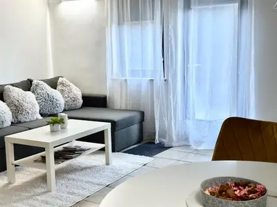 a living room with a couch and a table at Ground Floor Apt with a Pool and Terrace in Pesnica pri Mariboru
