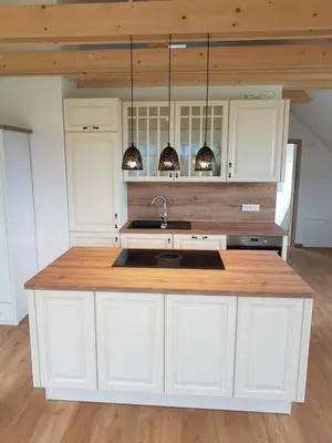 a kitchen with white cabinets and a sink at Garden Apartments Maria in Bled