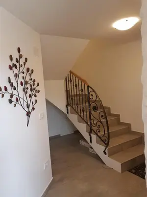 a staircase with a wrought iron railing in a house at Garden Apartments Maria in Bled